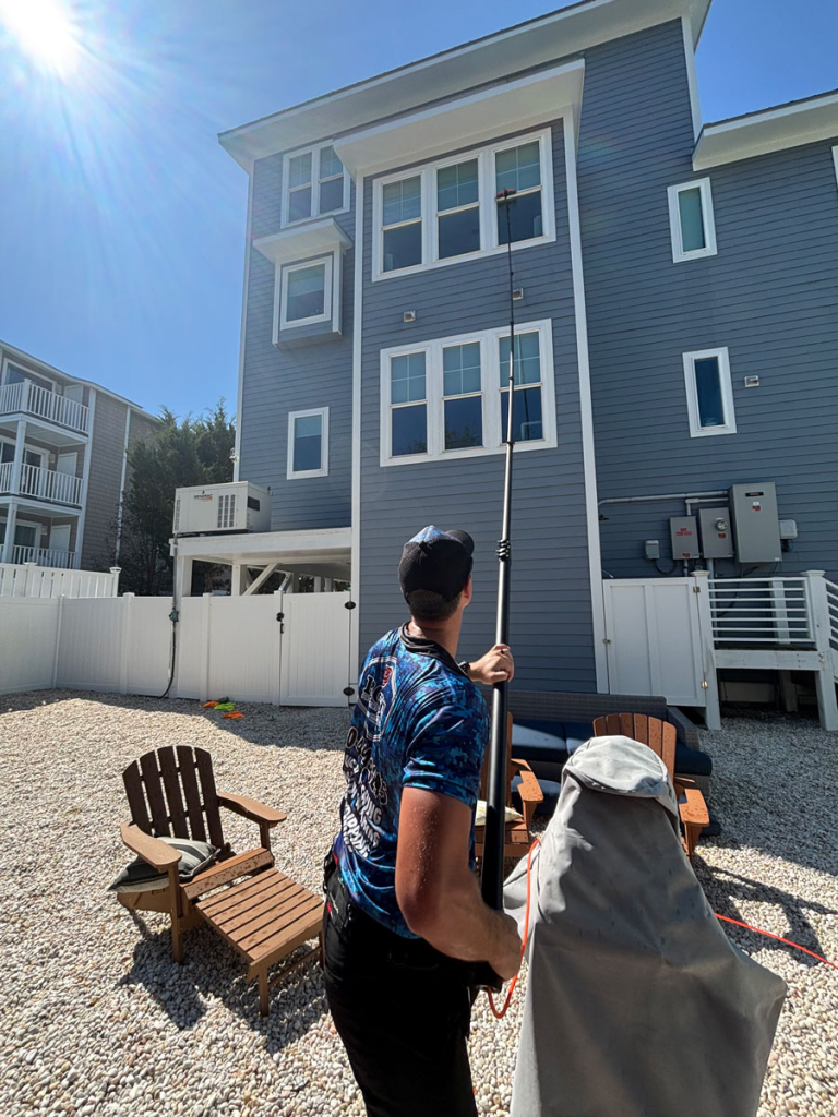 man cleaning top floor windows